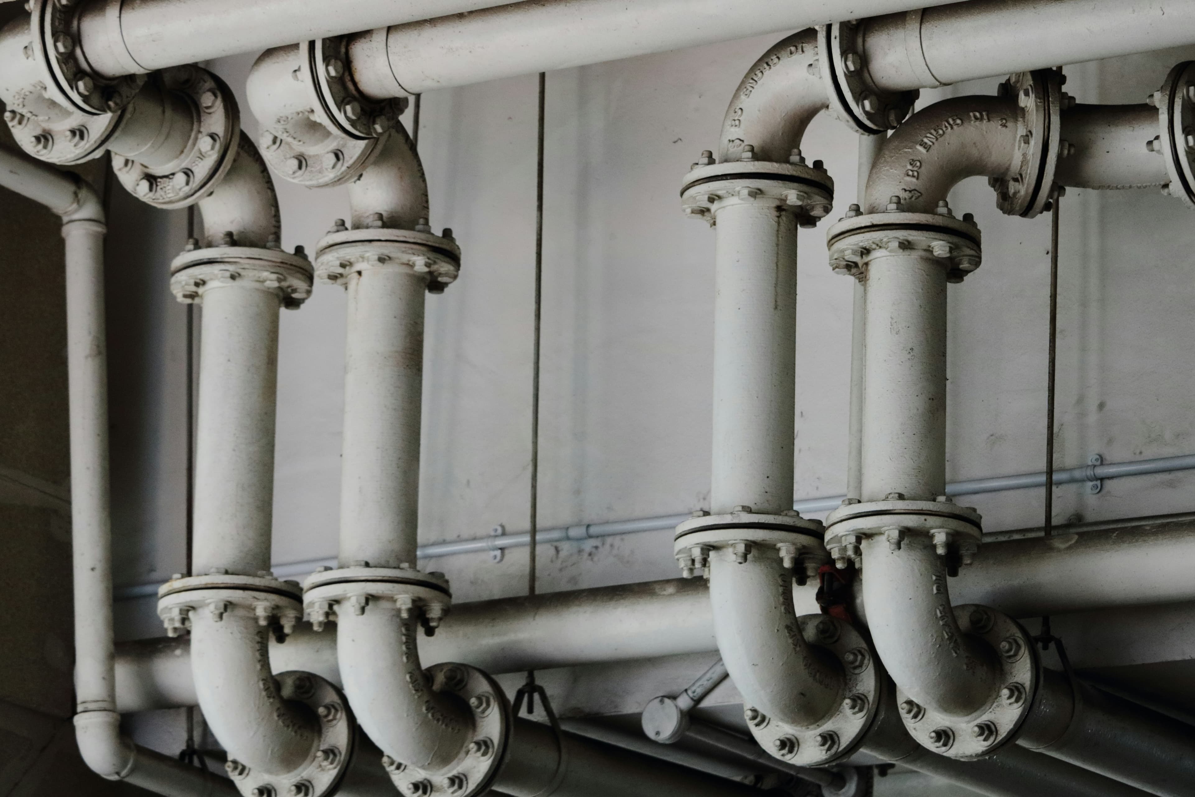 Rows of grey industrial process pipes