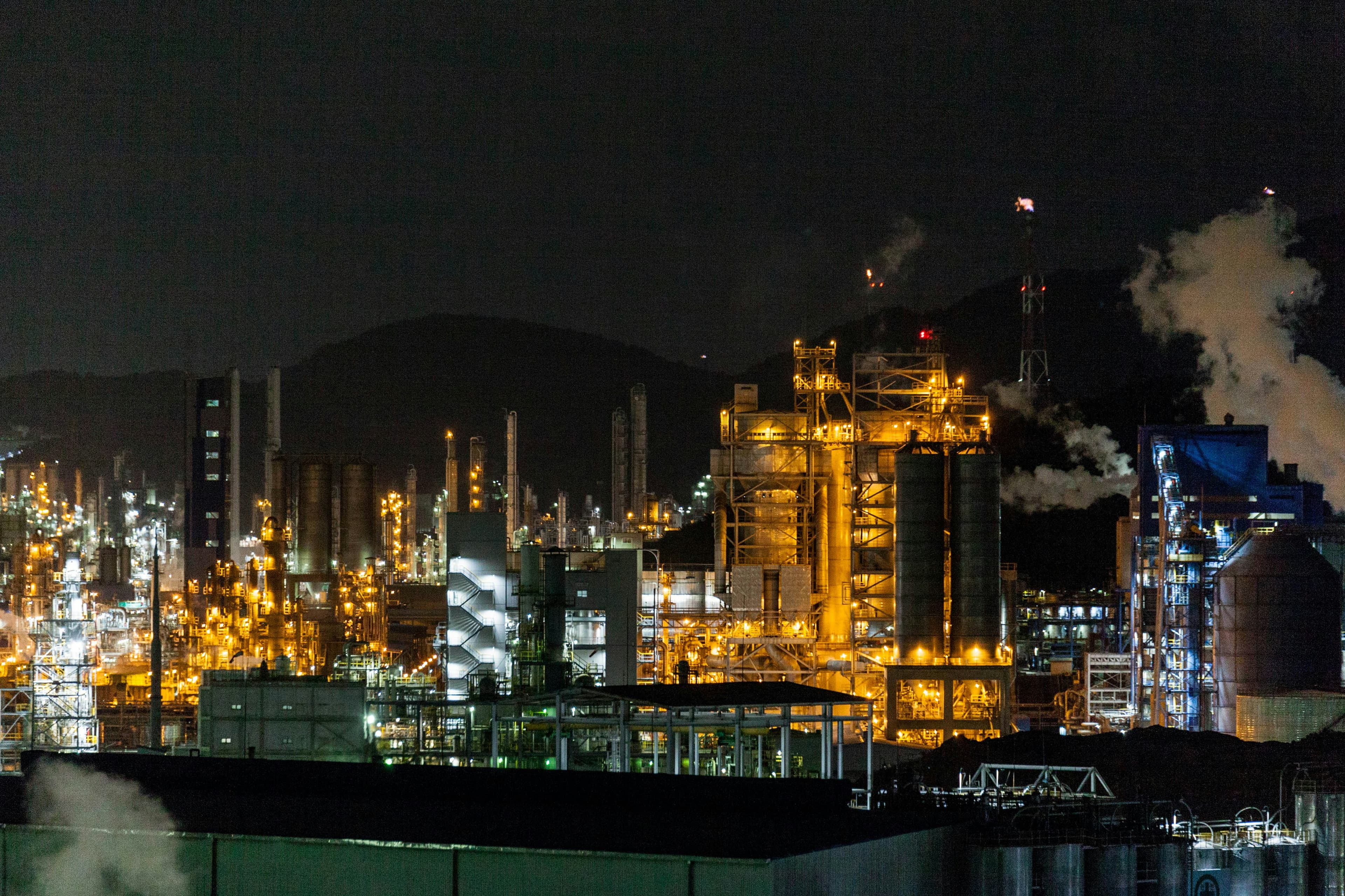 Petrochemical processing plant lit against the night sky